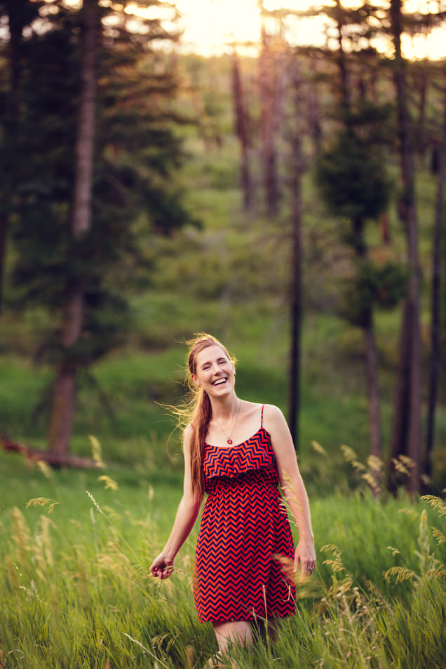 Kristine Paulsen Photography laughing and smiling in a field of grass