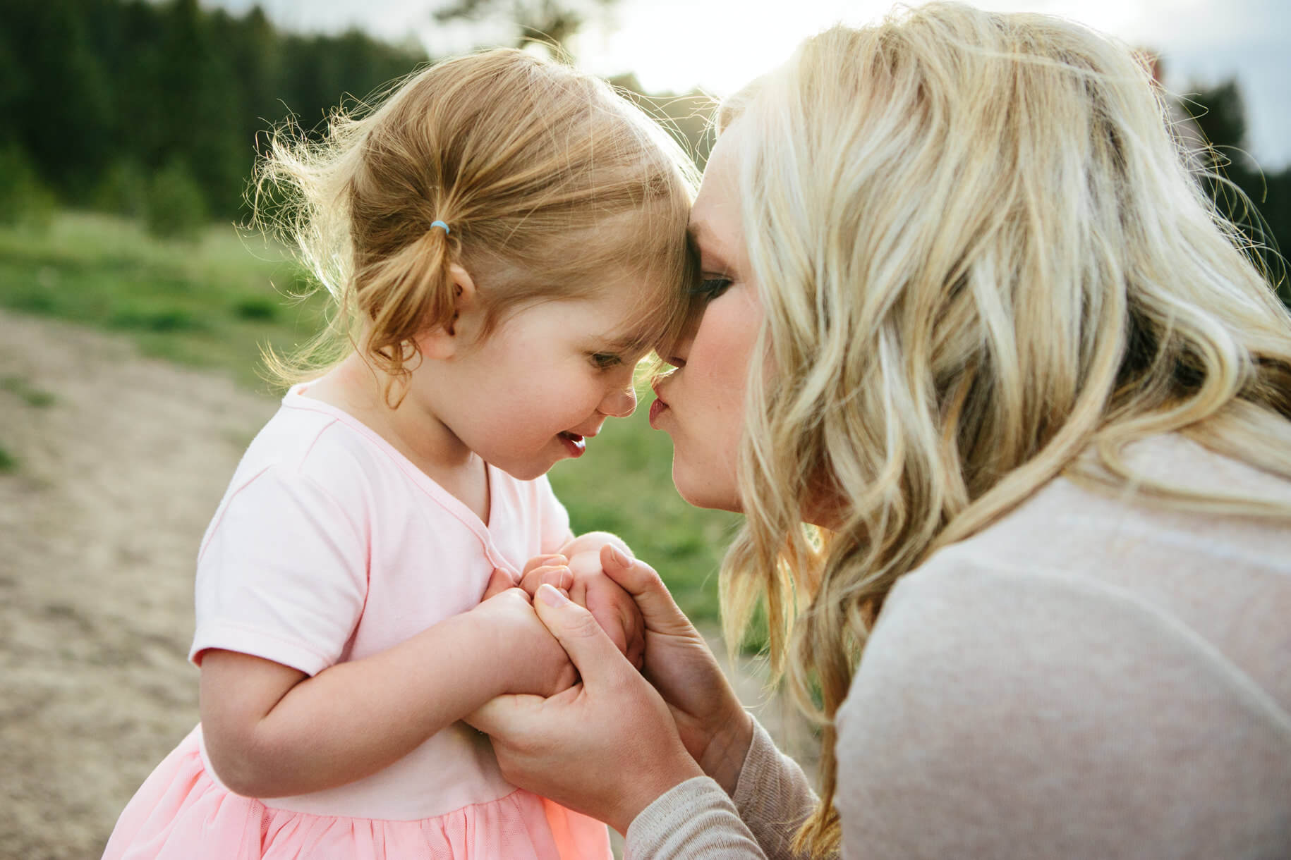 A mother kisses her toddler daughter on the nose during their family photos in Missoula Montana