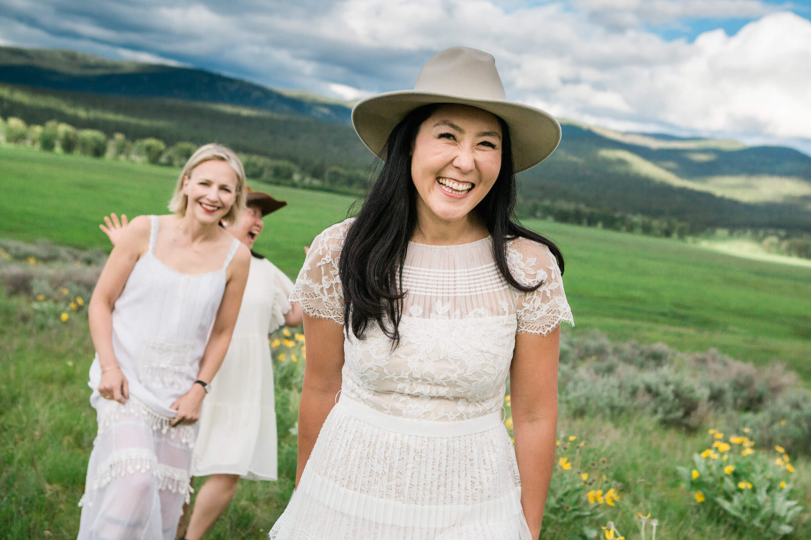 A woman smiles with her friends during their portrait session at Paws Up Resort in Montana