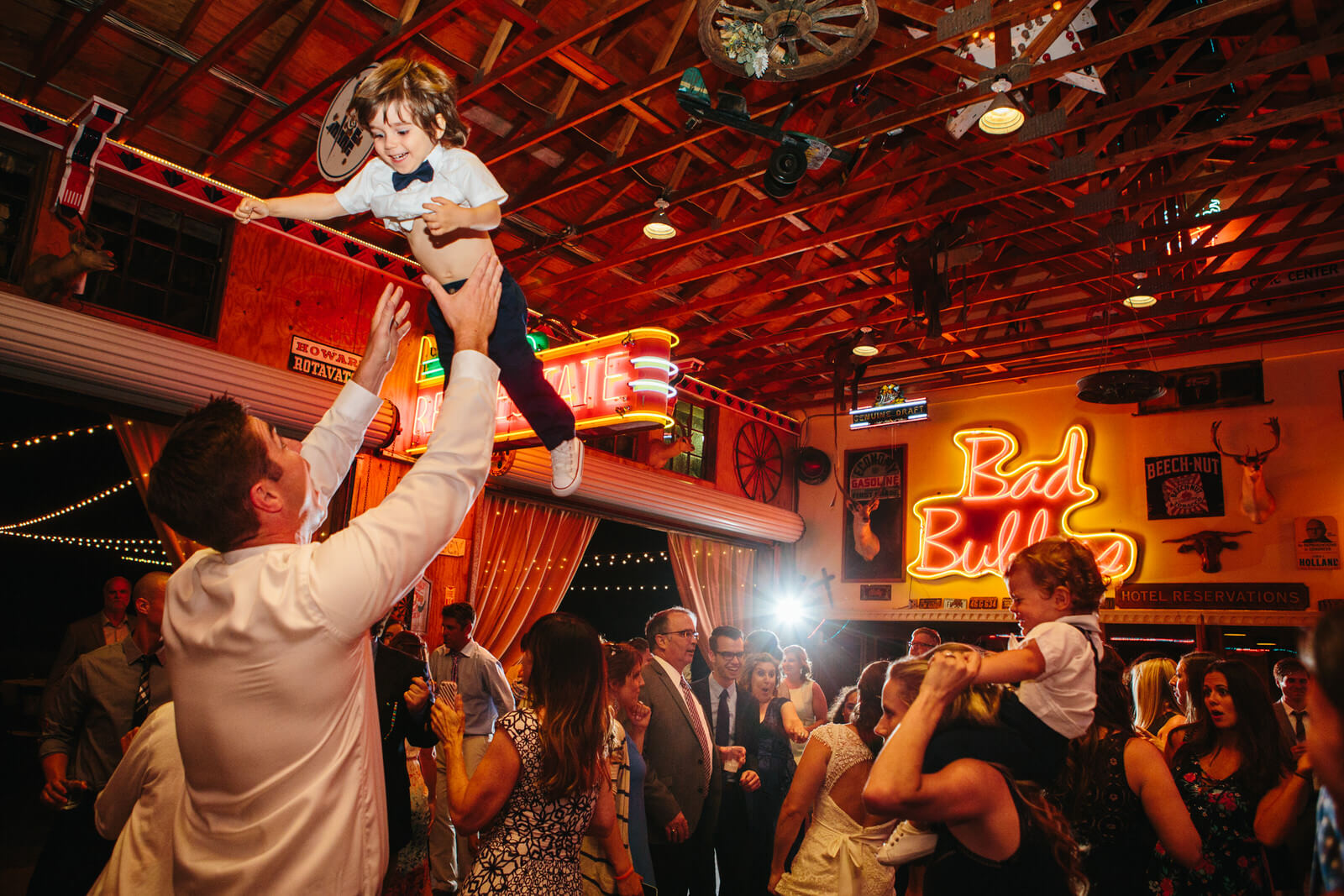 A small boy gets tossed into the air during a Holland Ranch wedding in San Luis Obispo California