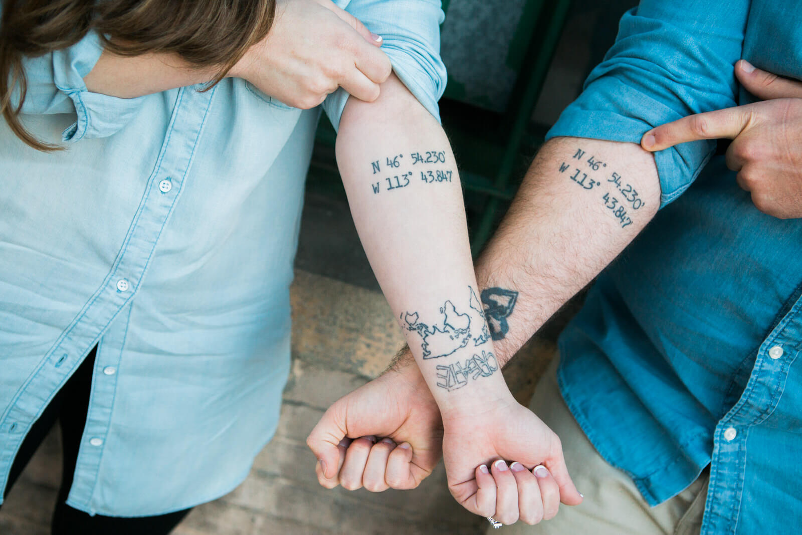 An engaged couple shows off their matching tattoos during their engagement session in Missoula Montana