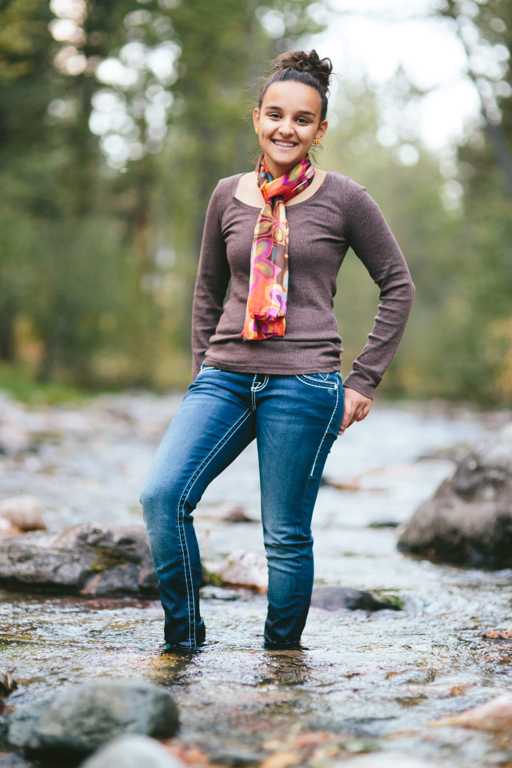 A senior girl stands in a creek during her Missoula Montana senior photos