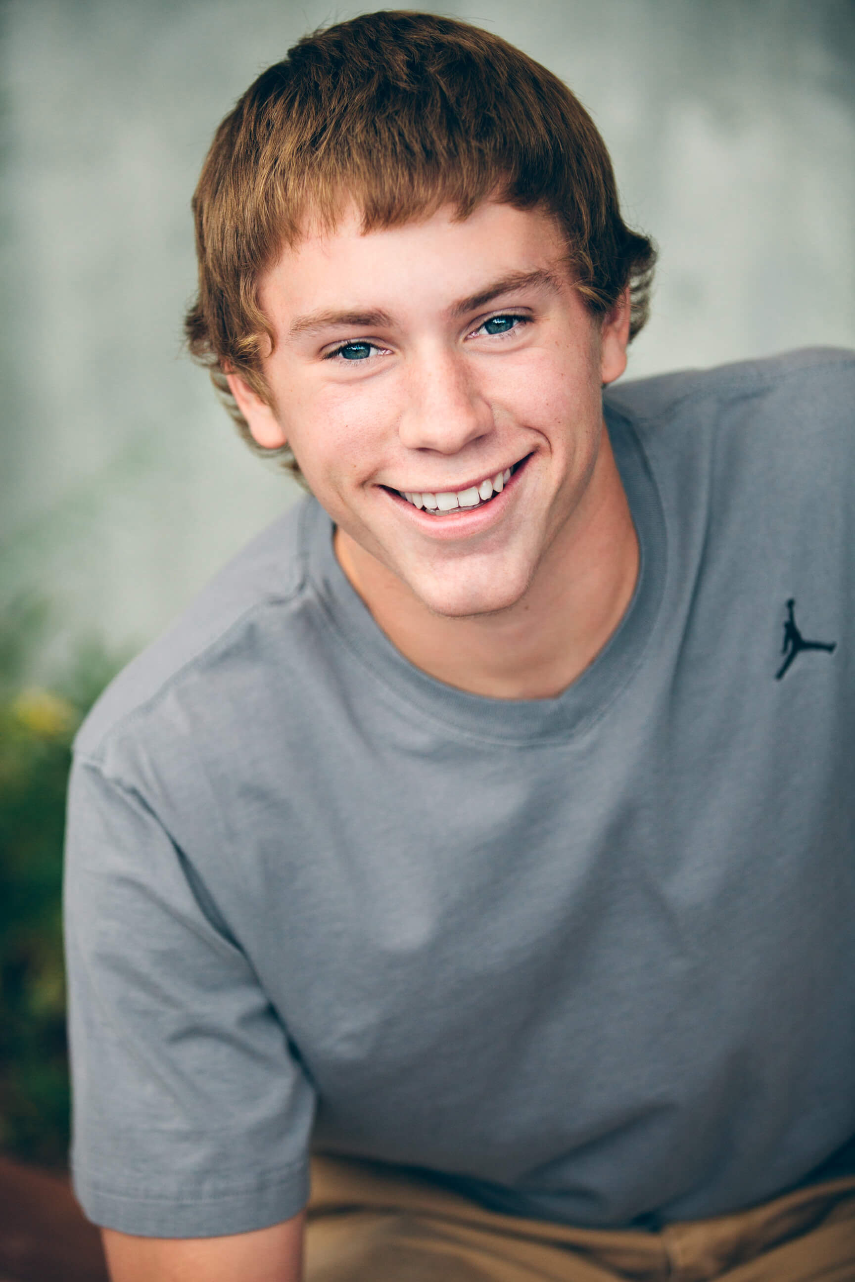 A senior boy smiles during his senior photo session in Missoula Montana