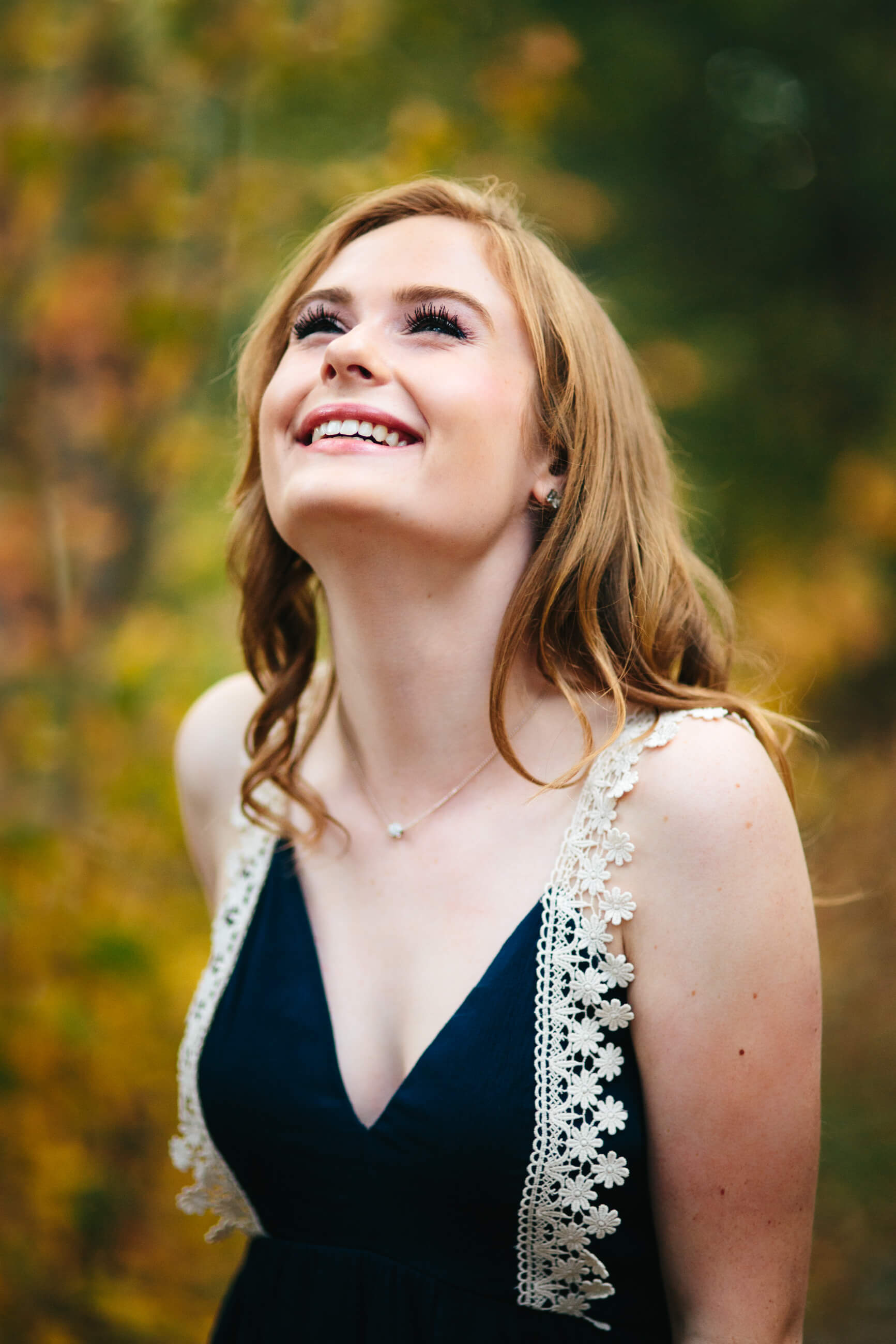 A senior girl laughs during her autumn senior photos in Missoula Montana