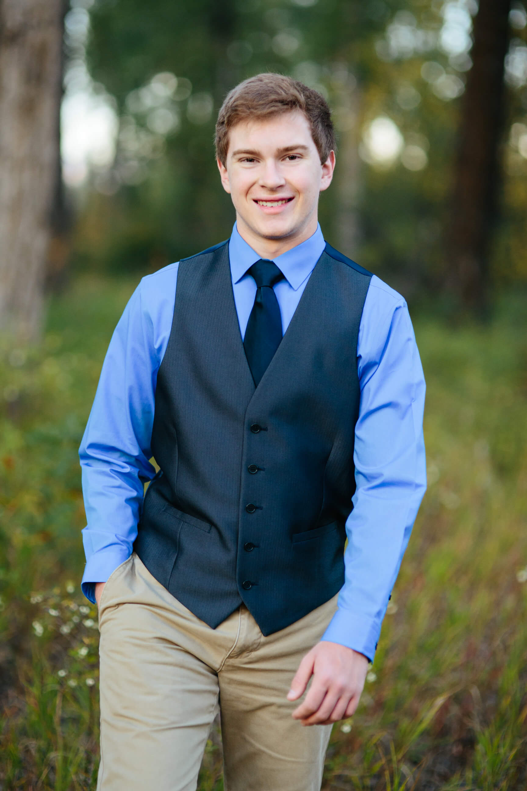 A senior boy smiles during his senior photos in Missoula Montana