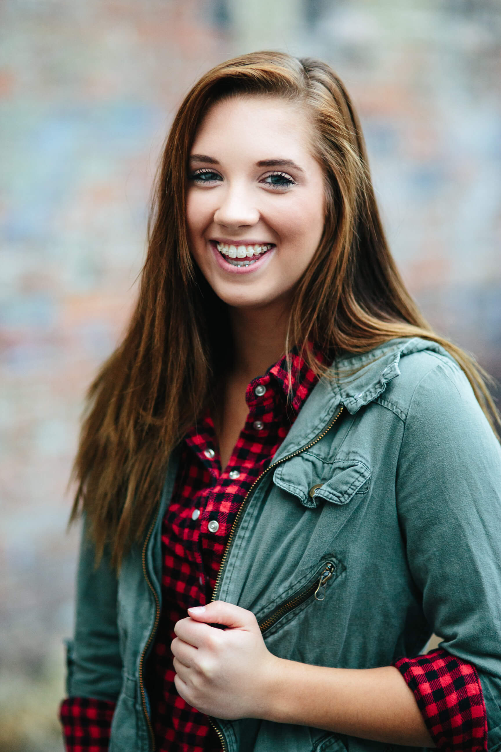 A senior girl laughs and smiles during her downtown Missoula senior photos