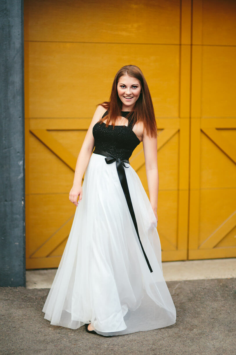 A high school senior girl twirls in her prom dress during her senior photos in Missoula Montana