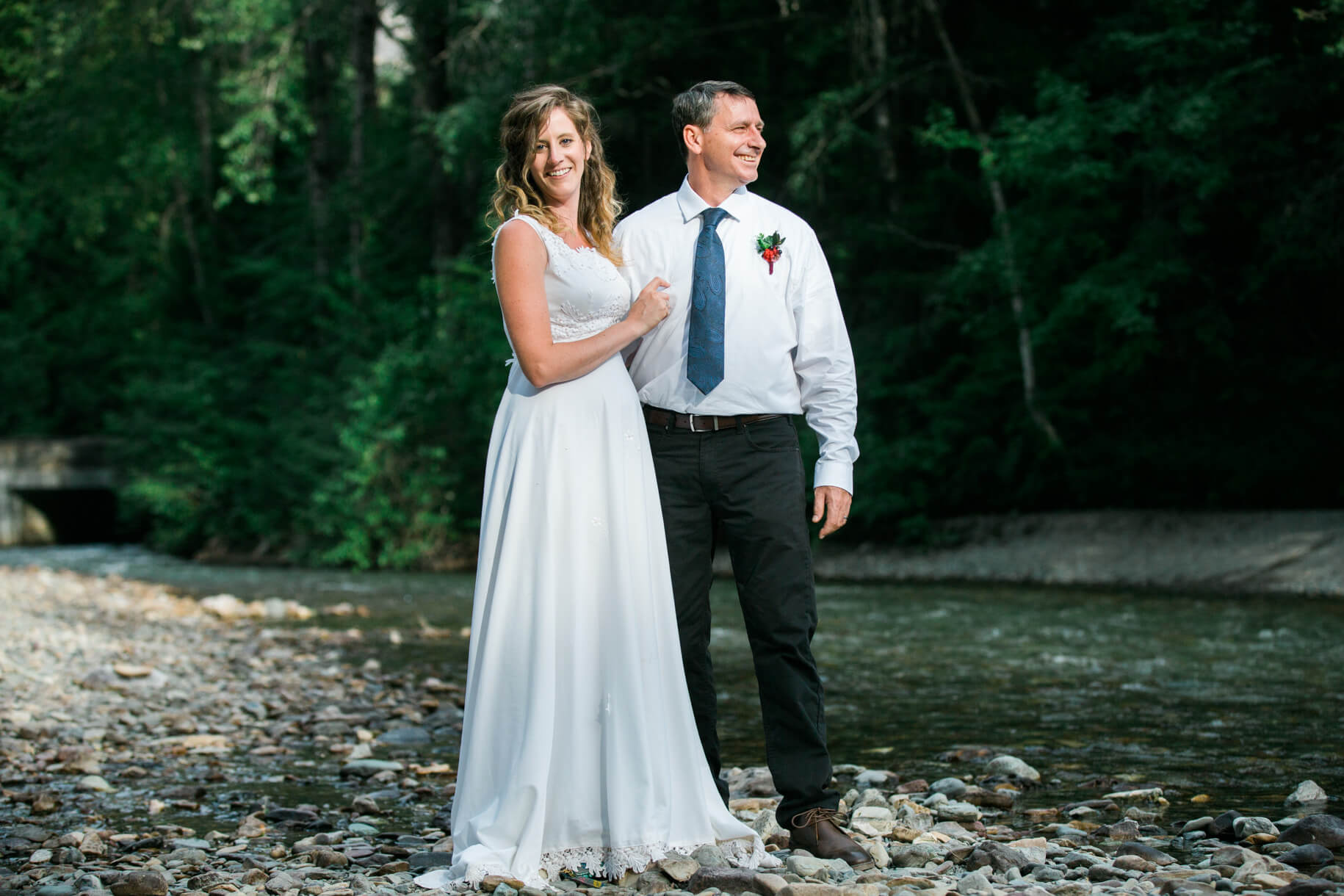 A bride and groom smile during their elopement in Glacier National Park in Montana